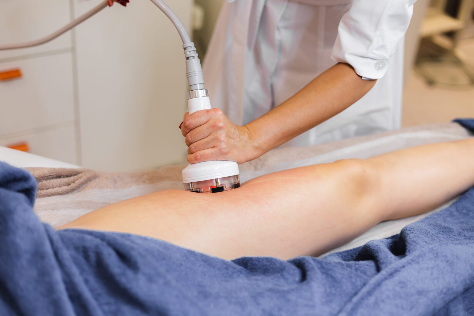 Masseur doing anti-cellulite massage to client in spa beauty salon using oil hanson
